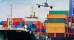 A large cargo ship with containers in the background.