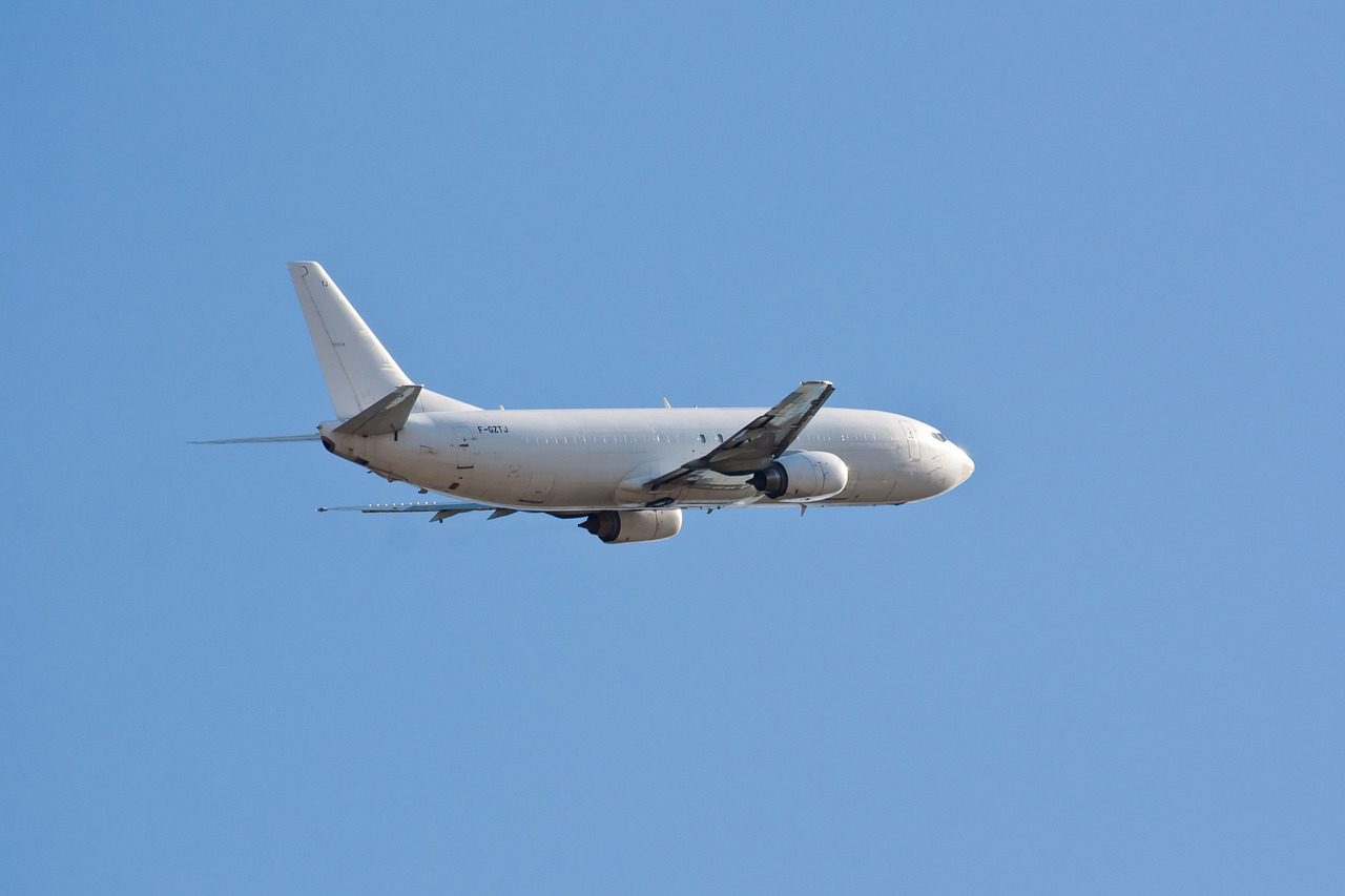 A large white airplane flying in the sky.