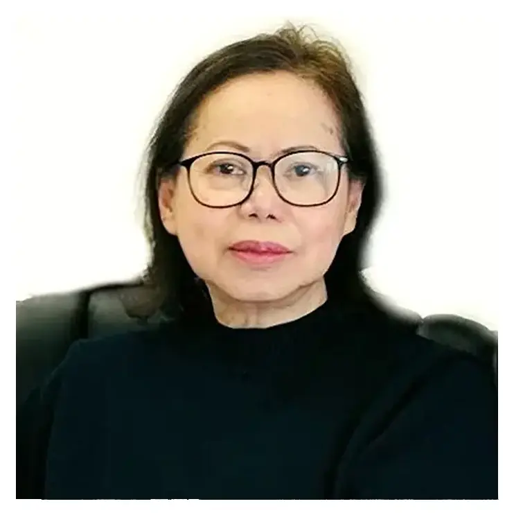 A woman with glasses sitting in an office chair.