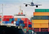 A large cargo ship with containers in the background.