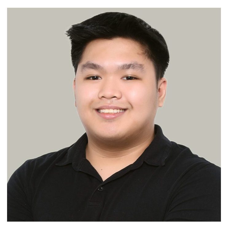 A man in black shirt smiling for the camera.